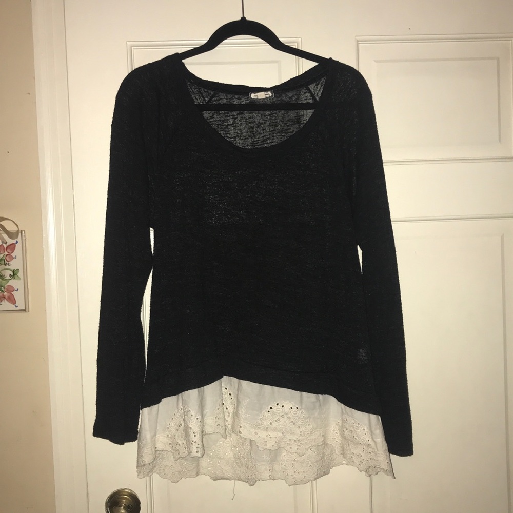 Long sleeved black top with a lacy trim
